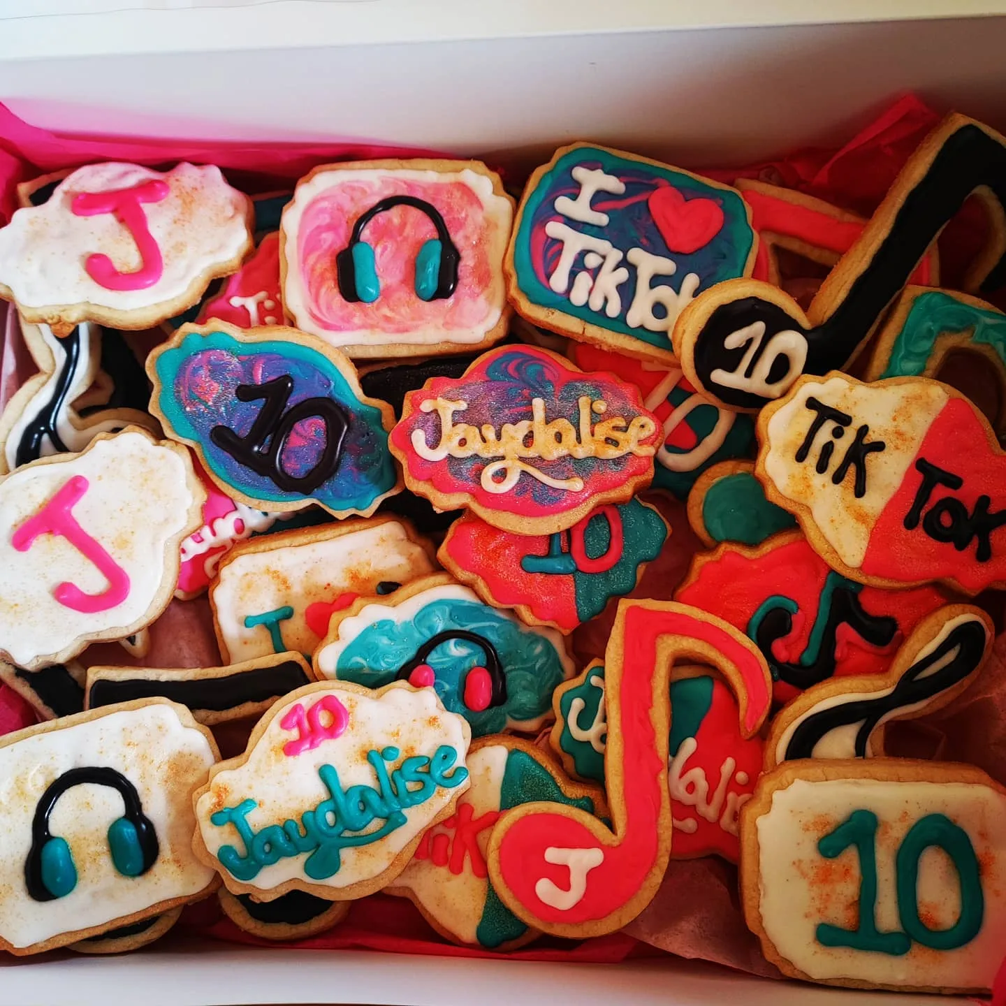 Customer photo of decorated sugar cookies with piped royal icing details using decorating tools