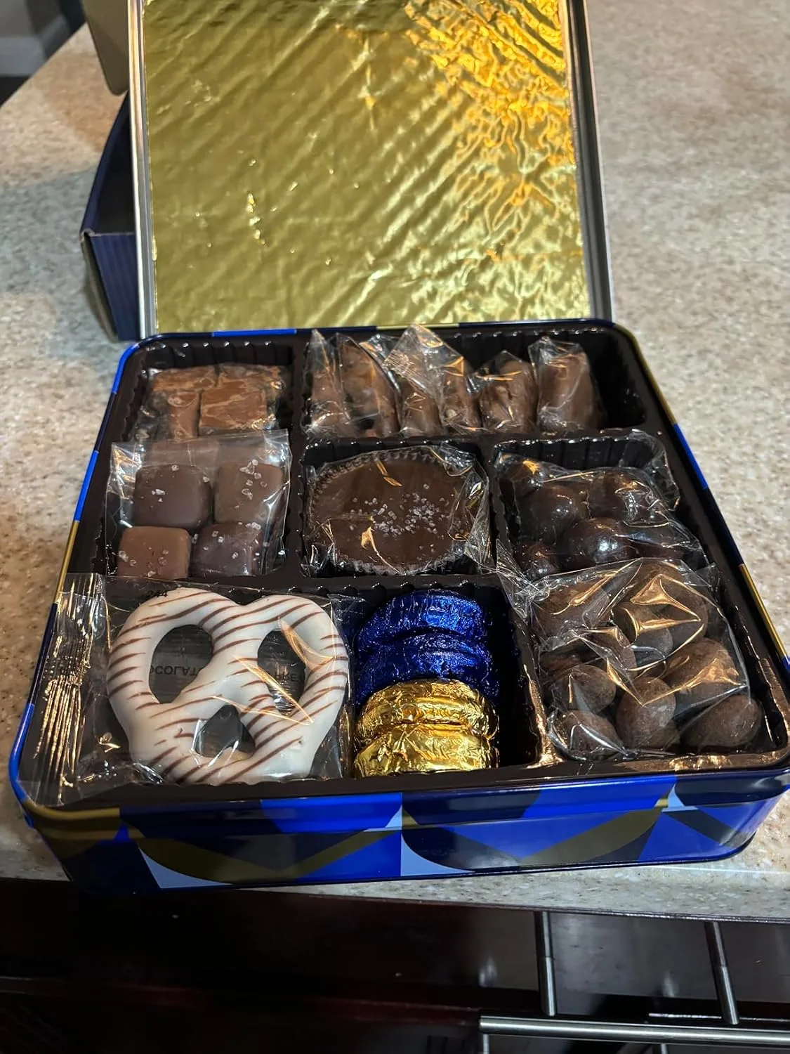 Customer photo of opened cookie box showing assorted gourmet cookies inside with packaging