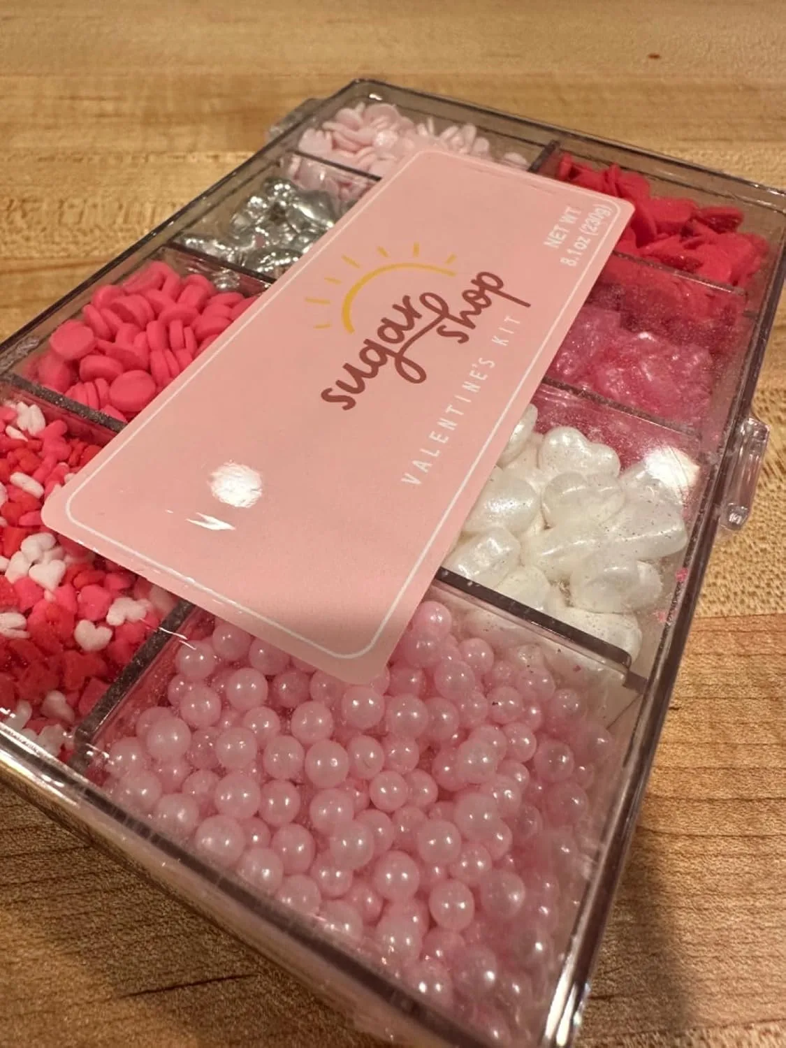 Customer photo of decorated sugar cookies arranged on a table with colorful icing and sprinkles