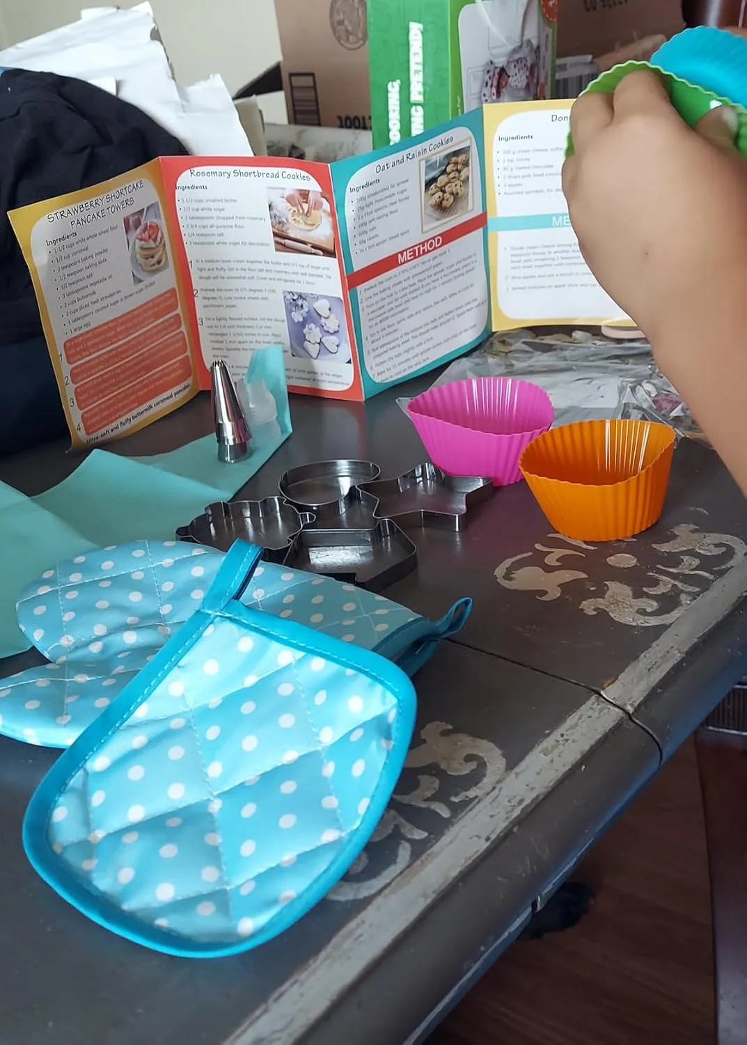 Customer photo of messy kitchen counter with flour and cookie dough during baking activity with young child