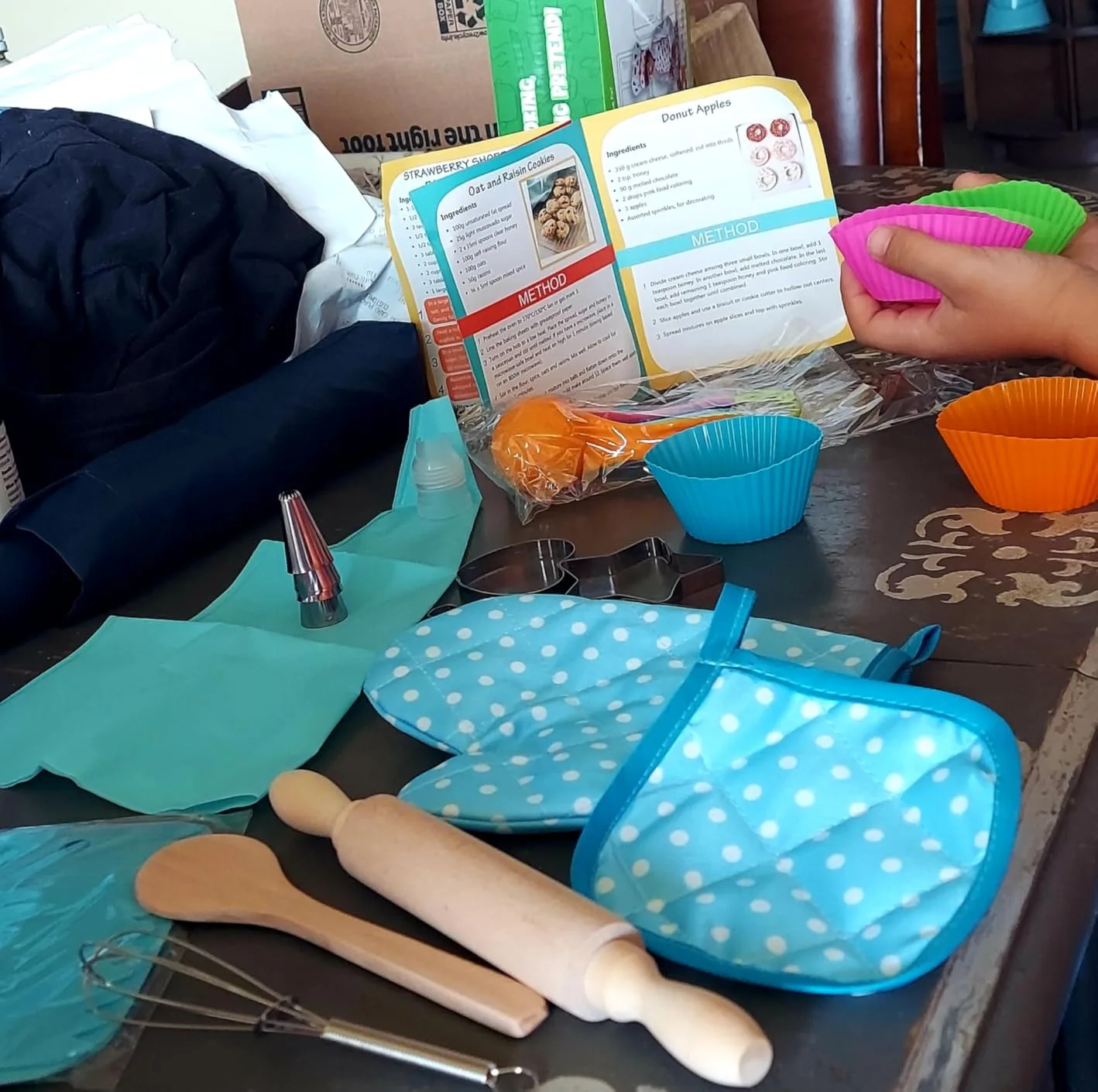 Customer photo of child's flour-covered hands during cookie baking activity