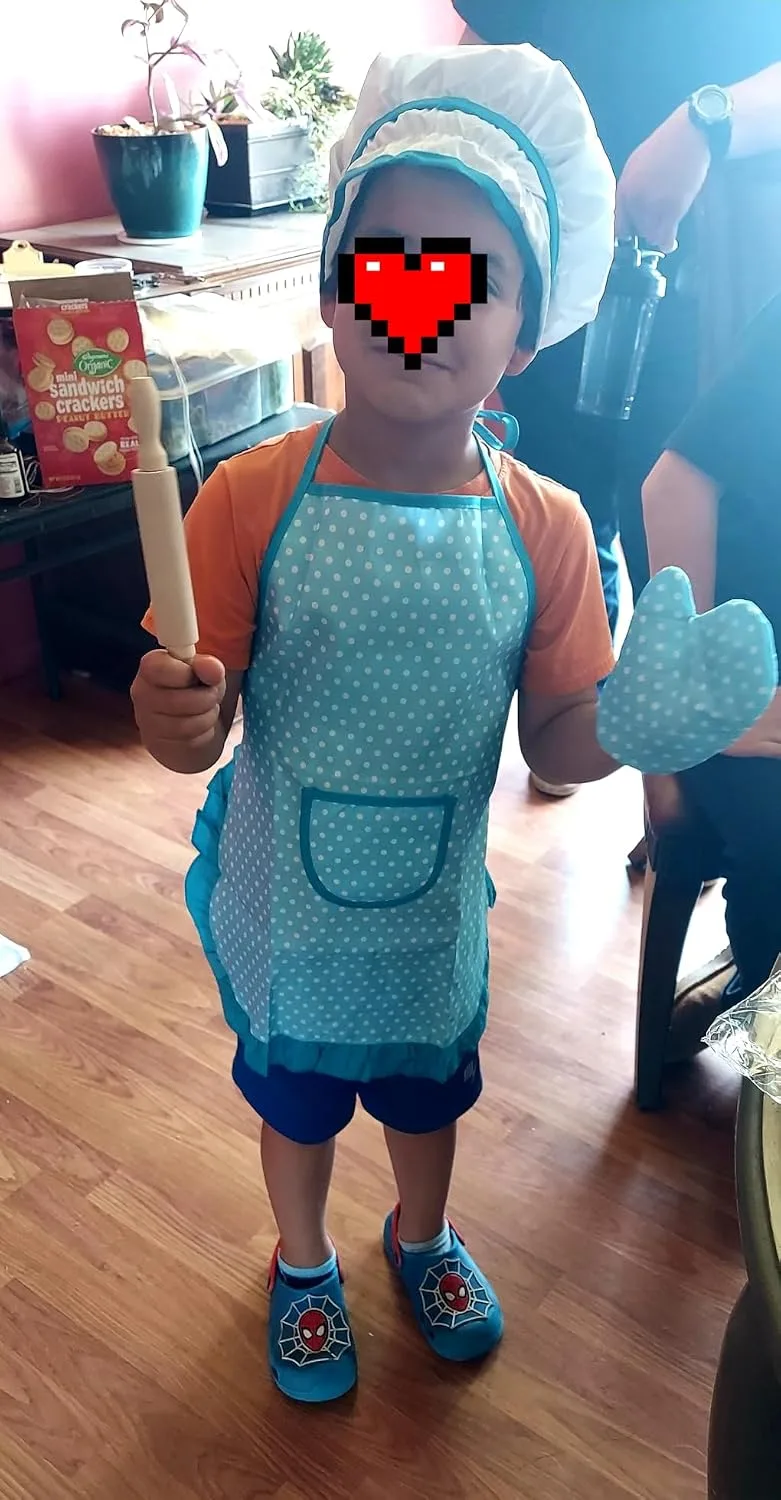 Customer photo of child's flour-covered hands and messy kitchen counter during baking activity
