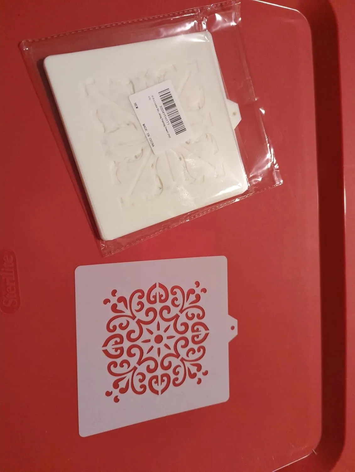 Customer photo of decorated sugar cookies with intricate stenciled designs in royal icing